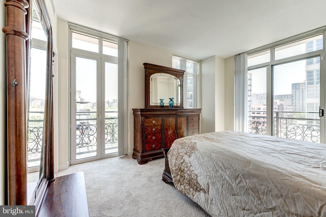 carpeted bedroom with access to exterior and expansive windows
