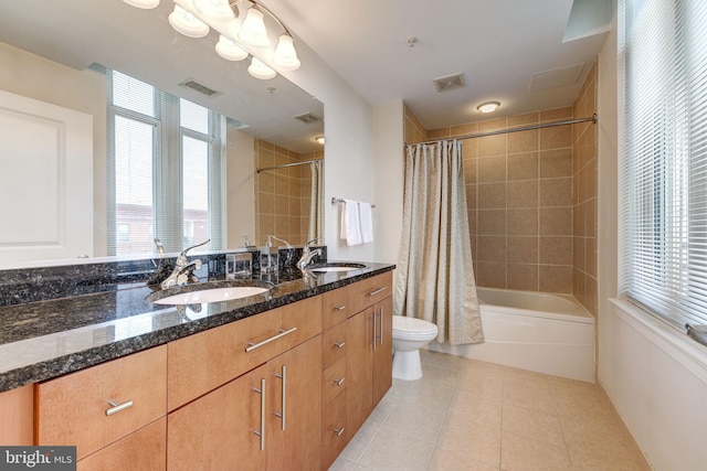 bathroom with a sink, visible vents, toilet, and tile patterned floors