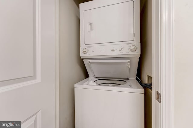 clothes washing area with laundry area and stacked washer / drying machine