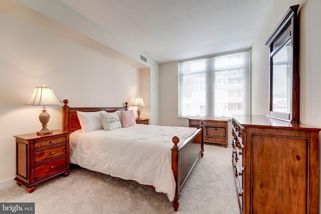 bedroom with visible vents and light colored carpet