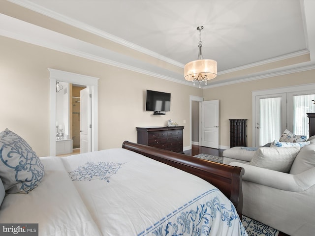 bedroom with a raised ceiling, wood finished floors, and crown molding