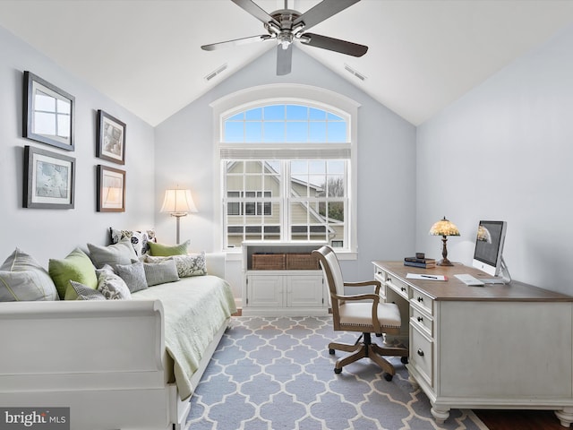 carpeted home office with vaulted ceiling, visible vents, and ceiling fan