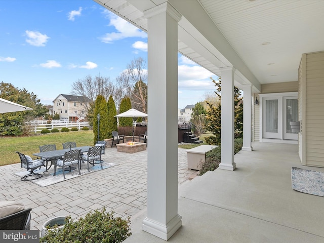 view of patio / terrace with outdoor dining space, an outdoor fire pit, and fence
