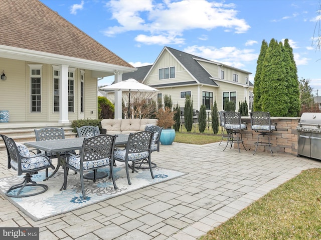 view of patio / terrace with area for grilling, exterior kitchen, and outdoor dining area