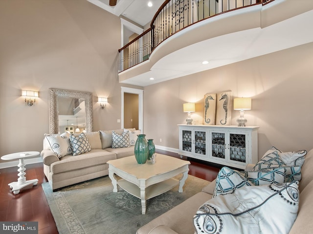 living room featuring a high ceiling, recessed lighting, wood finished floors, and baseboards