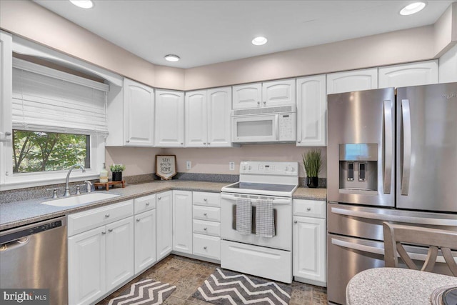 119 Rieck Ave, Millville, NJ 08332 - kitchen featuring appliances with stainless steel finishes, a sink, white cabinets, recessed lighting, and light countertops
