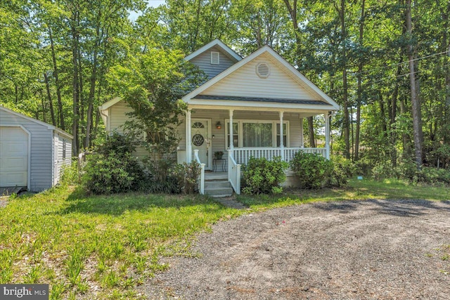 119 Rieck Ave, Millville, NJ 08332 - view of front facade with covered porch, an outdoor structure, and a garage