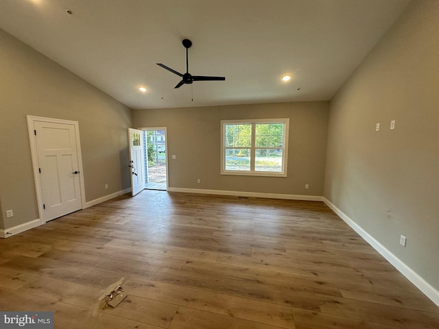 interior space with lofted ceiling, wood finished floors, a wealth of natural light, and ceiling fan