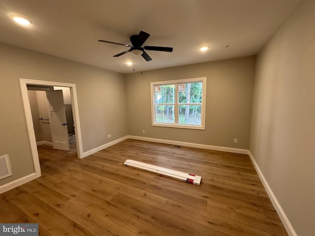unfurnished bedroom featuring hardwood / wood-style flooring, recessed lighting, baseboards, and visible vents