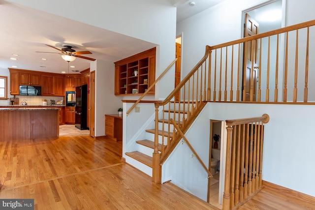 stairway featuring recessed lighting, a ceiling fan, and wood finished floors