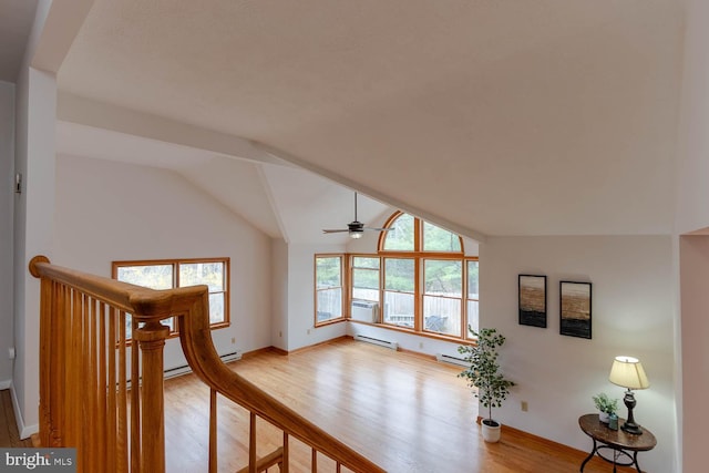 living area with baseboards, vaulted ceiling, light wood-style floors, ceiling fan, and a baseboard radiator