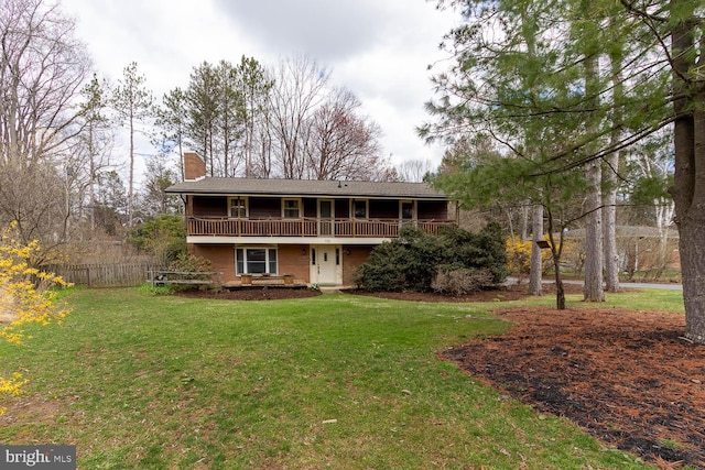 view of front facade with fence, a chimney, and a front lawn
