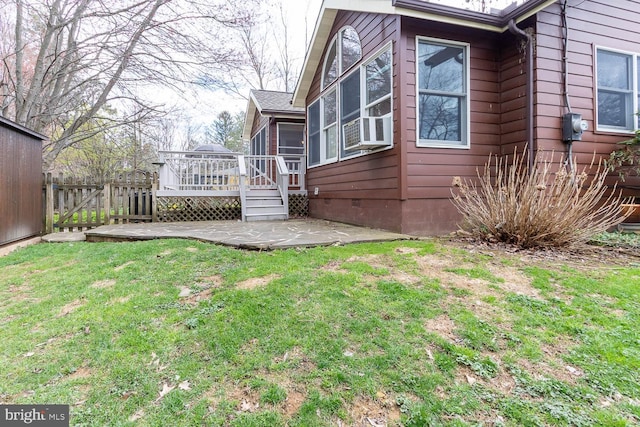 view of home's exterior with crawl space, a patio area, a wooden deck, fence, and a lawn