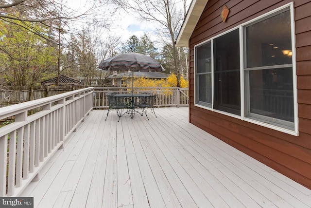 wooden terrace featuring outdoor dining area