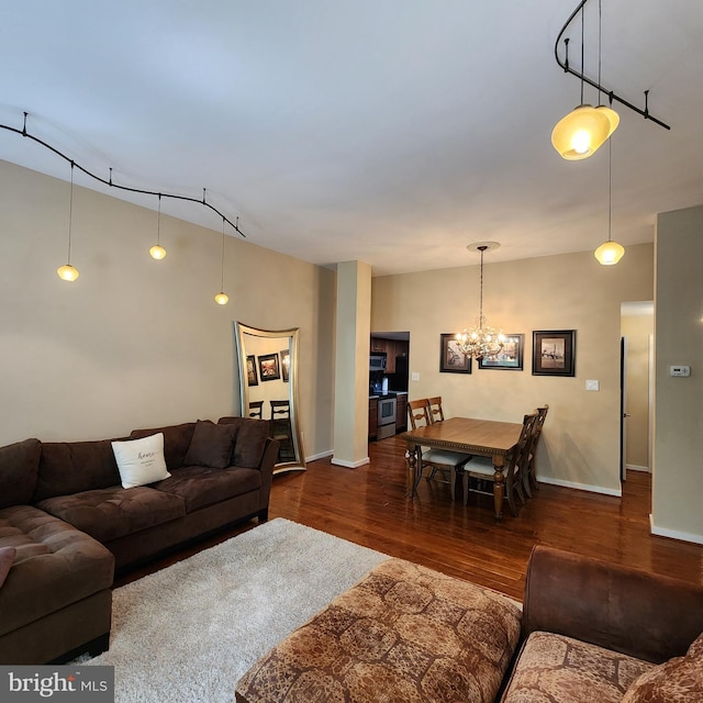 1023 Clinton St Unit 204, Philadelphia, PA 19107 - living area with an inviting chandelier, wood finished floors, and baseboards
