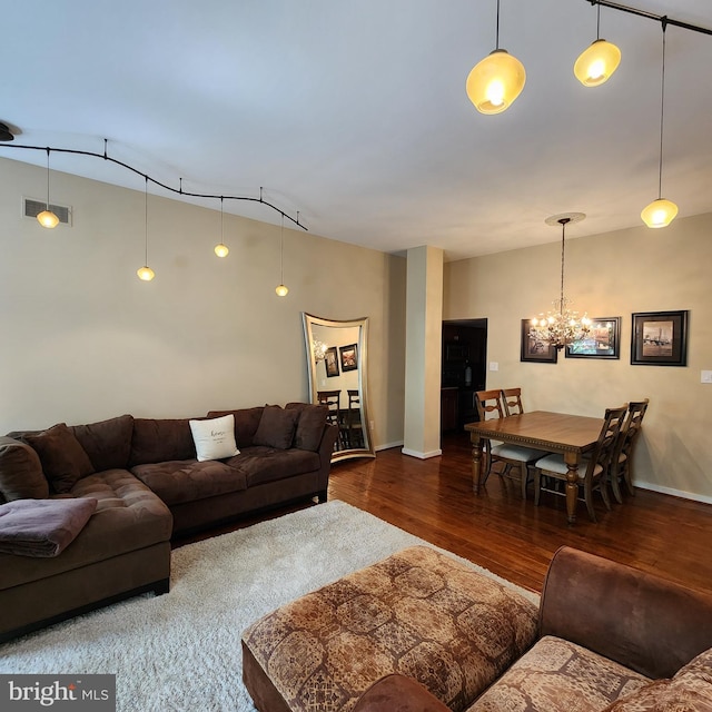 1023 Clinton St Unit 204, Philadelphia, PA 19107 - living room with wood finished floors, baseboards, visible vents, and a notable chandelier