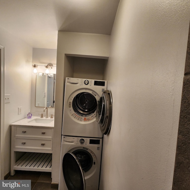 1023 Clinton St Unit 204, Philadelphia, PA 19107 - washroom featuring stacked washer and clothes dryer, tile patterned flooring, laundry area, and a sink