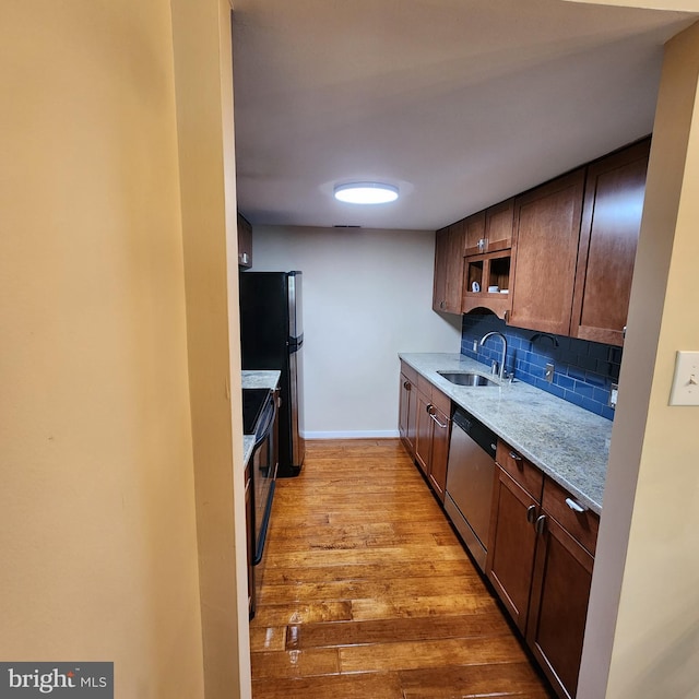 1023 Clinton St Unit 204, Philadelphia, PA 19107 - kitchen with tasteful backsplash, stainless steel dishwasher, a sink, light wood-style floors, and baseboards