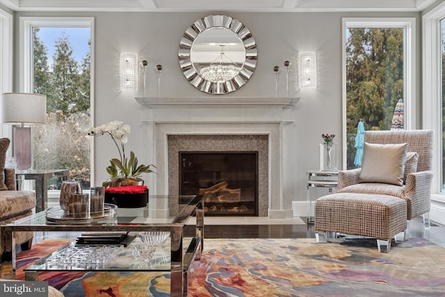 sitting room with an inviting chandelier and a fireplace with flush hearth