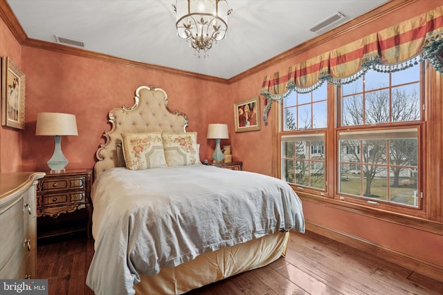 bedroom featuring baseboards, a chandelier, visible vents, and hardwood / wood-style floors