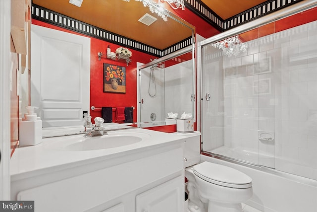 full bathroom featuring vanity, enclosed tub / shower combo, toilet, and visible vents