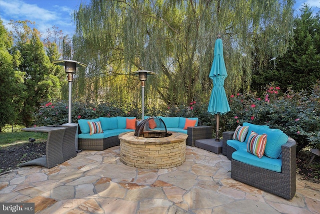 view of patio featuring an outdoor living space with a fire pit