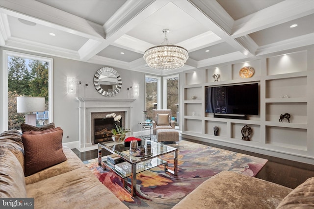 living area with wood finished floors, beam ceiling, a high end fireplace, a chandelier, and coffered ceiling