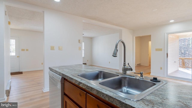 159 Yancey Ct, Mc Gaheysville, VA 22840 - kitchen with dishwashing machine, light wood-style floors, brown cabinetry, a textured ceiling, and a sink