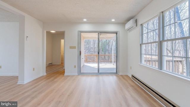 159 Yancey Ct, Mc Gaheysville, VA 22840 - empty room featuring a wall unit AC, baseboards, a textured ceiling, light wood-type flooring, and baseboard heating