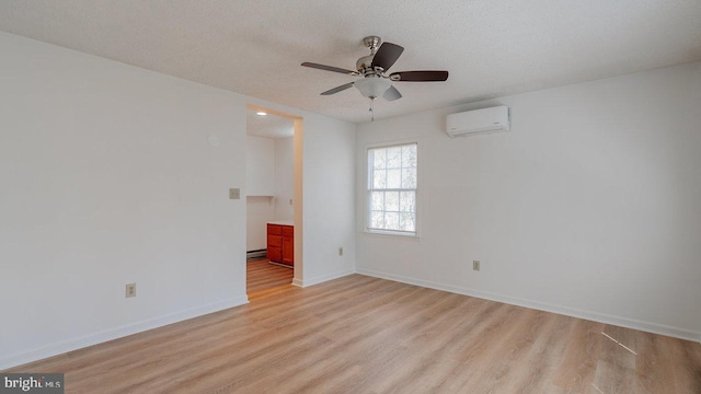 159 Yancey Ct, Mc Gaheysville, VA 22840 - empty room with baseboards, ceiling fan, light wood-style flooring, a textured ceiling, and a wall mounted AC