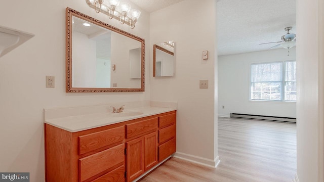159 Yancey Ct, Mc Gaheysville, VA 22840 - bathroom with a ceiling fan, a textured ceiling, wood finished floors, a baseboard radiator, and vanity