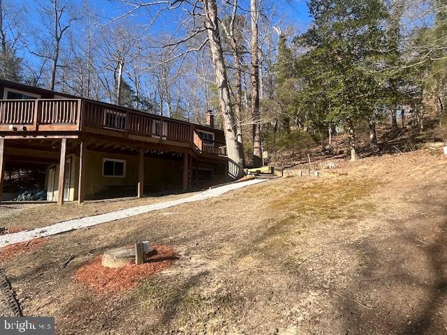 view of side of property featuring a wooden deck