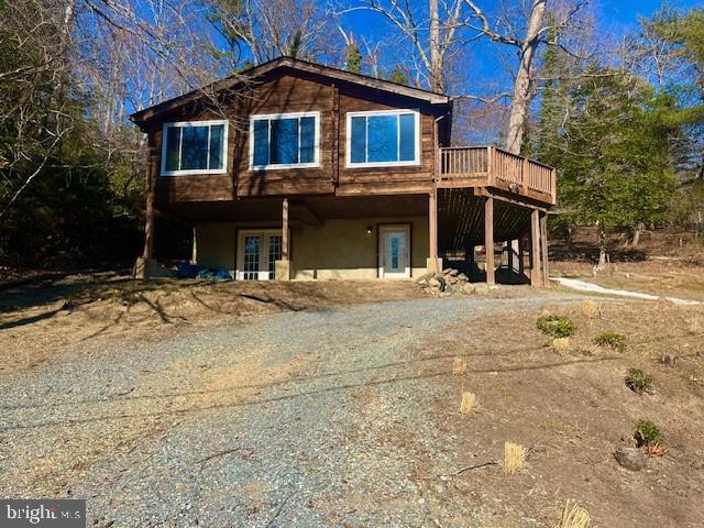 back of house with a deck and stucco siding