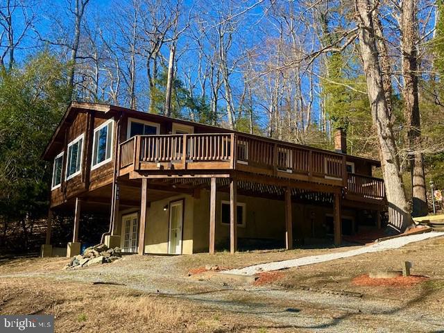 back of property featuring stucco siding and a wooden deck