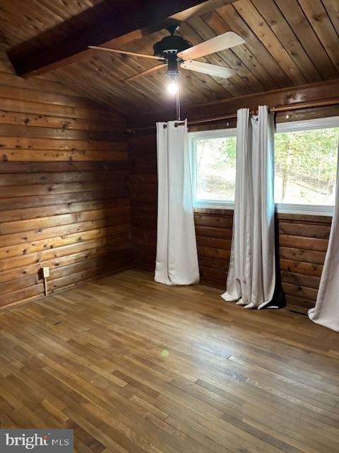 interior space with hardwood / wood-style flooring, lofted ceiling with beams, wood ceiling, and ceiling fan