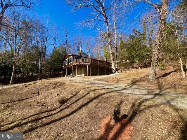 rear view of property featuring a wooden deck