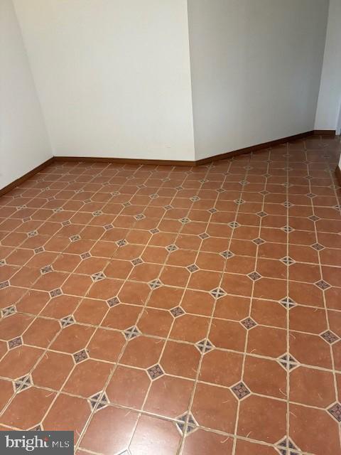 spare room featuring baseboards