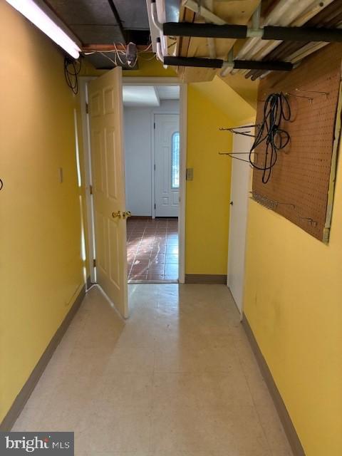 hall featuring baseboards