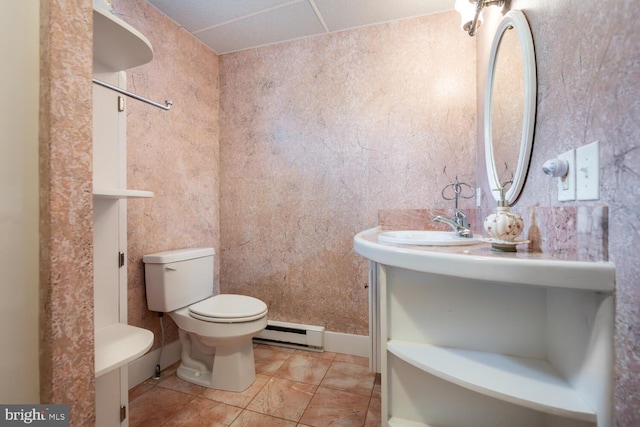 bathroom with toilet, baseboard heating, and vanity