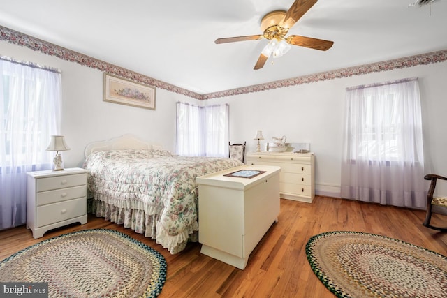 bedroom featuring light wood-type flooring and a ceiling fan