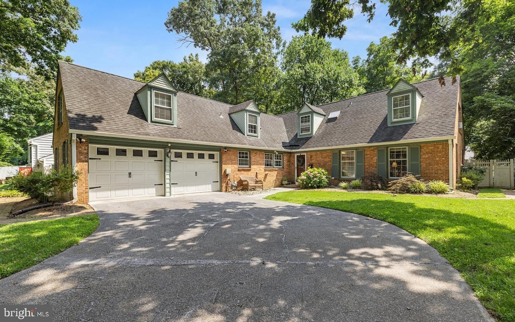 1555 Farlow Ave, Crofton, MD 21114 - cape cod house with brick siding, asphalt driveway, an attached garage, and a shingled roof