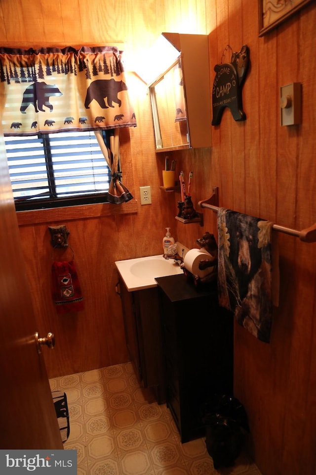 bathroom featuring wood walls and vanity