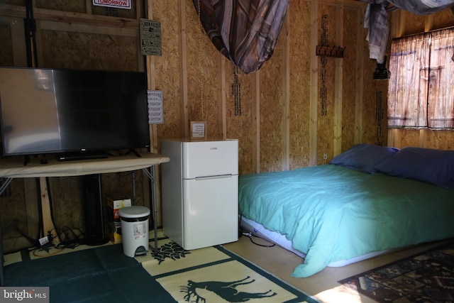 bedroom featuring freestanding refrigerator