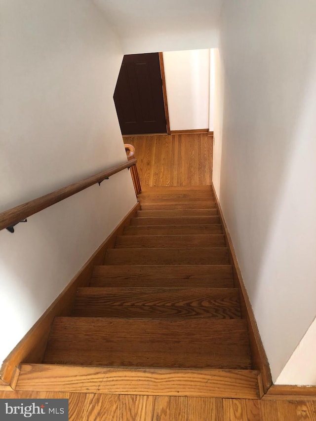 staircase with wood finished floors