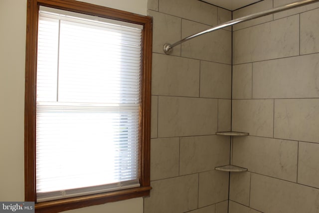 bathroom with a tile shower