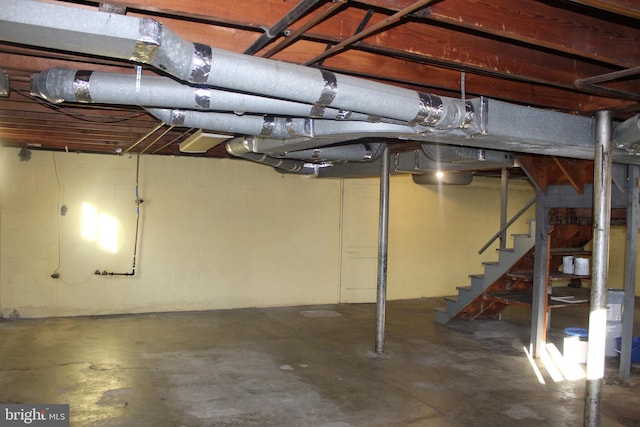unfinished below grade area featuring stairway