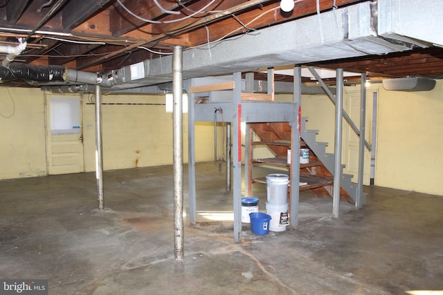 unfinished basement featuring stairs