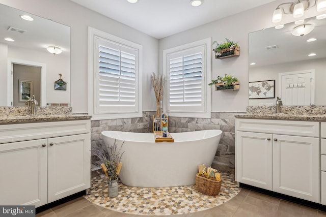52 Olivia Way, Chesterfield, NJ 08515 - bathroom with two vanities, tile walls, a wainscoted wall, recessed lighting, and a freestanding bath