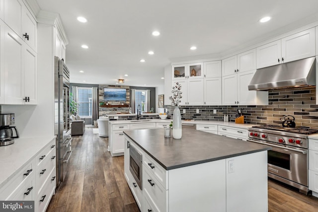 52 Olivia Way, Chesterfield, NJ 08515 - kitchen with under cabinet range hood, stainless steel appliances, backsplash, a peninsula, and a sink