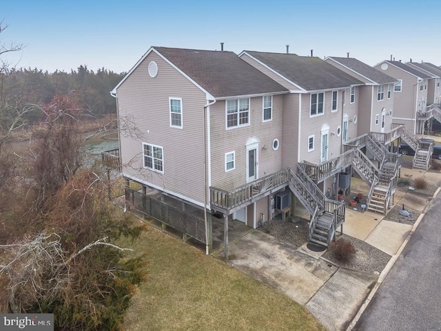 view of building exterior featuring a garage, driveway, and stairway